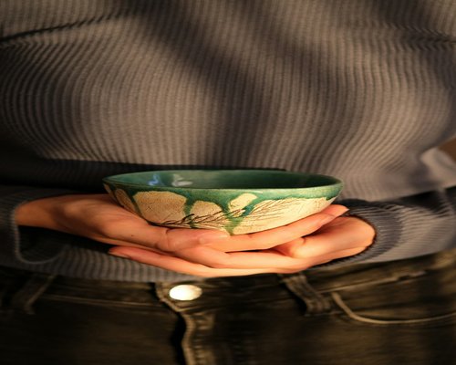 Person holding a cup of herbal tea enjoying calm moment